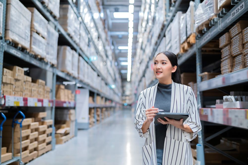 Female busines person checking inventory in warehouse
