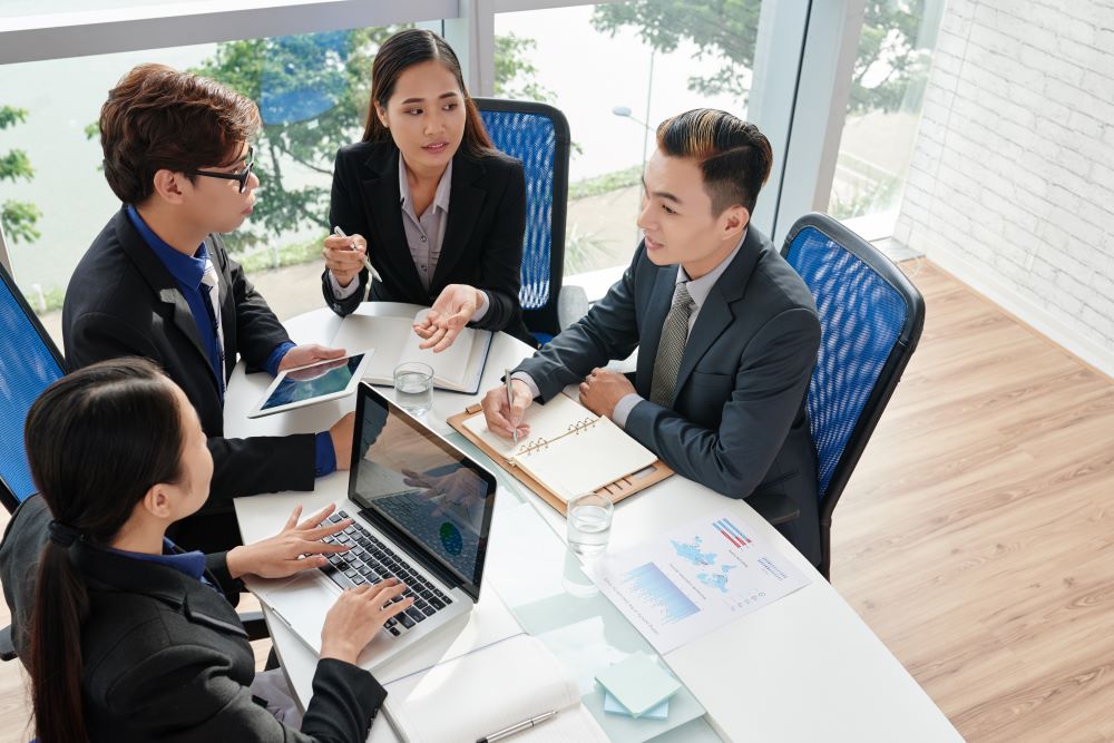 Four business people at table having a meeting